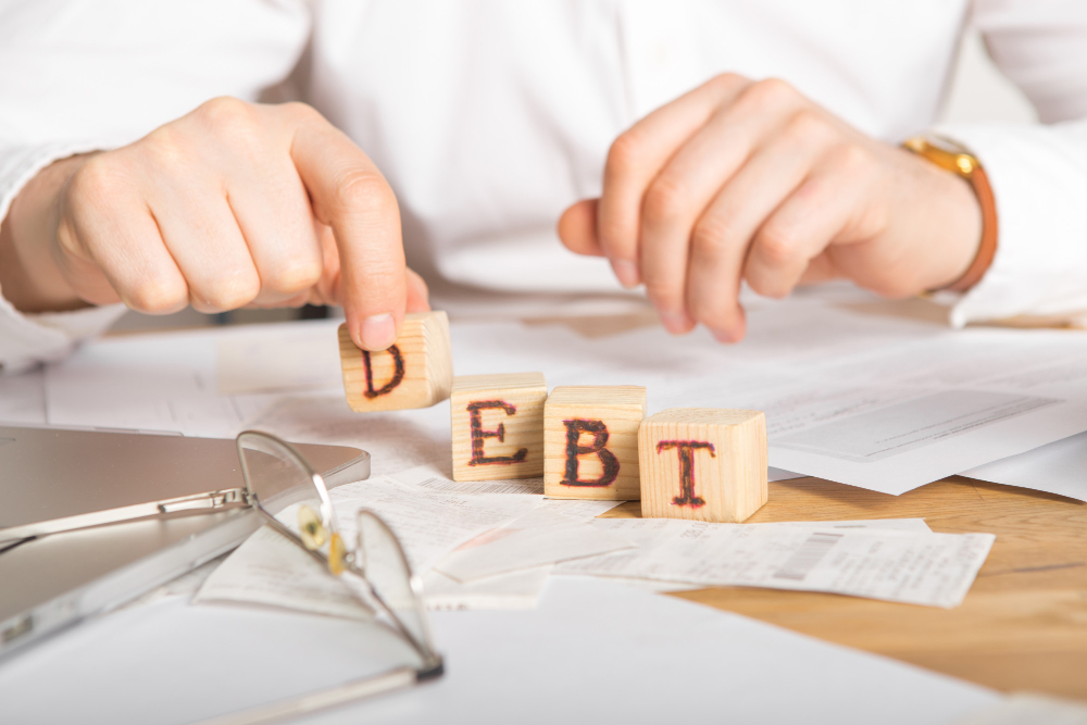 businessman-holding-wooden-cube-with-tax-word
